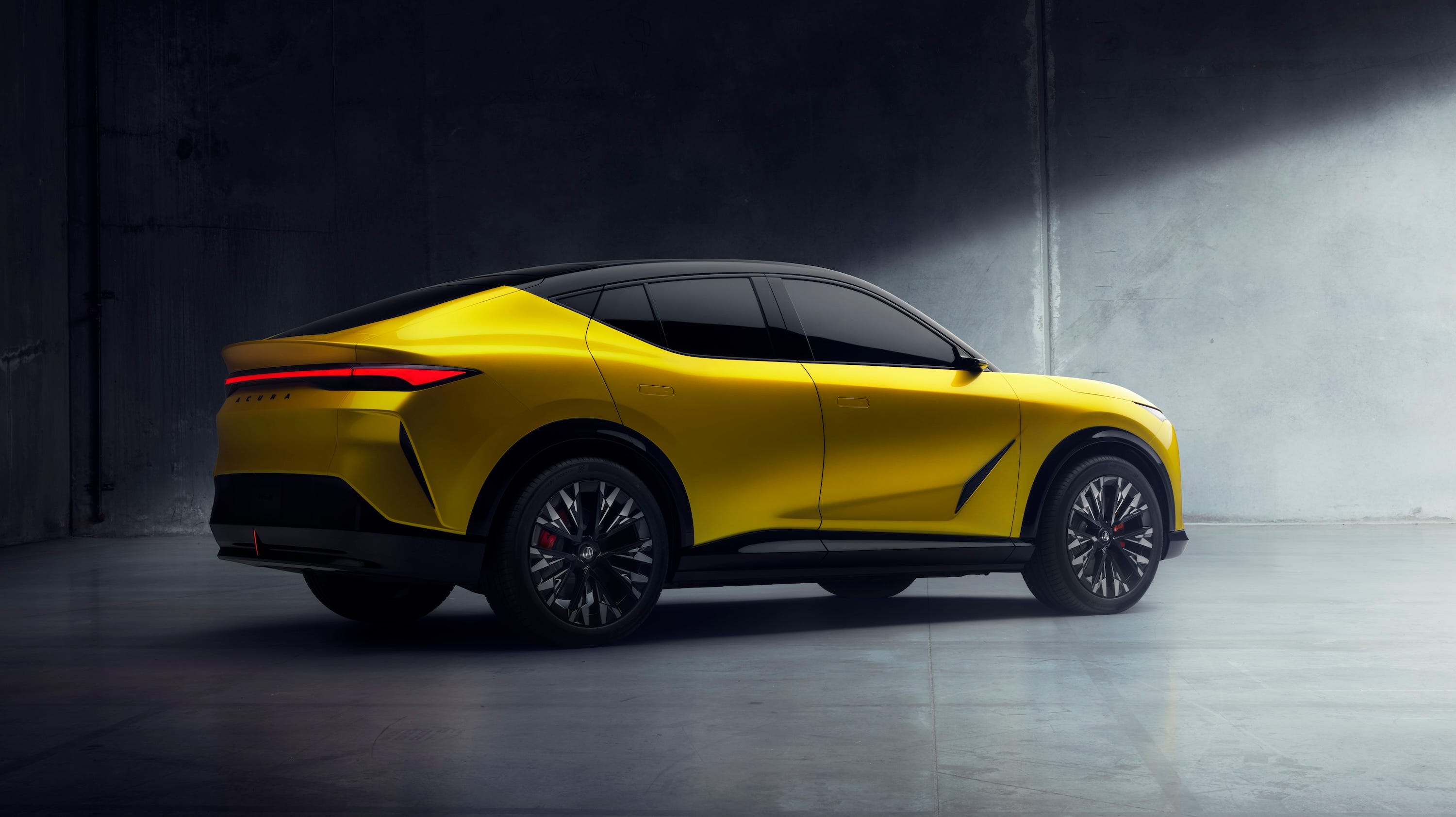 The black-painted roof contrasts with the electric SUV's brightly colored Propulsion Yellow Pearl Paint.