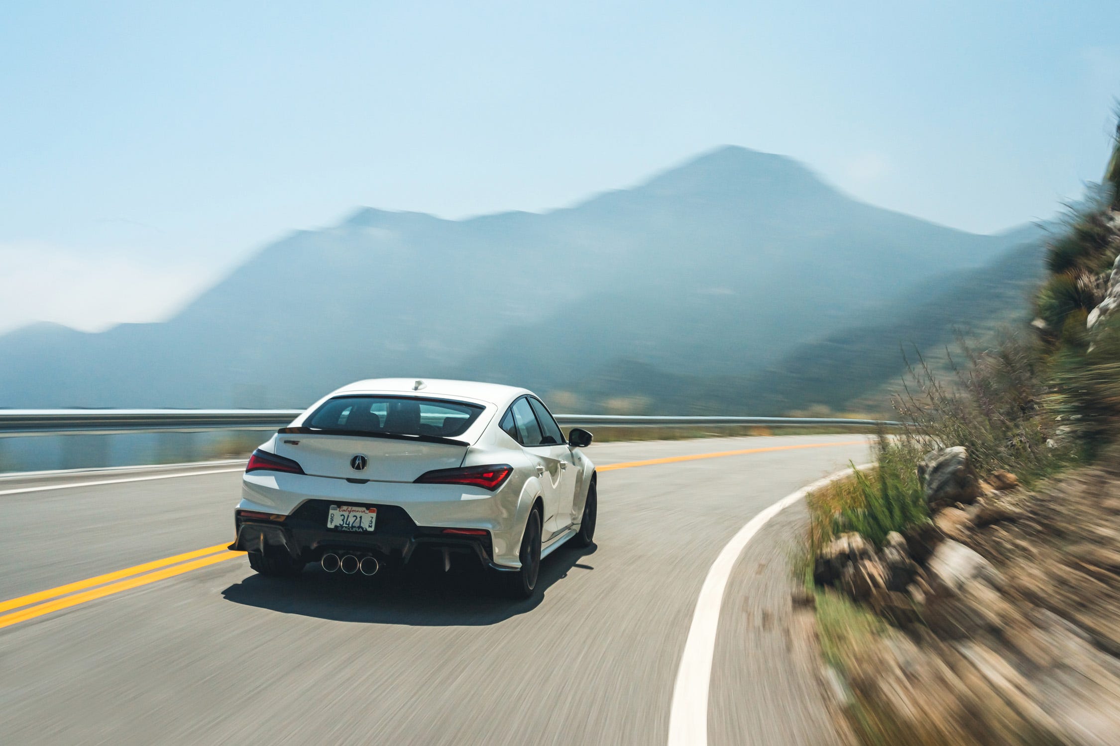 The Type R's rear swing is replaced by a lip spoiler on the Type S. The triple exhaust outlets remain, but the exhaust system is tuned differently.